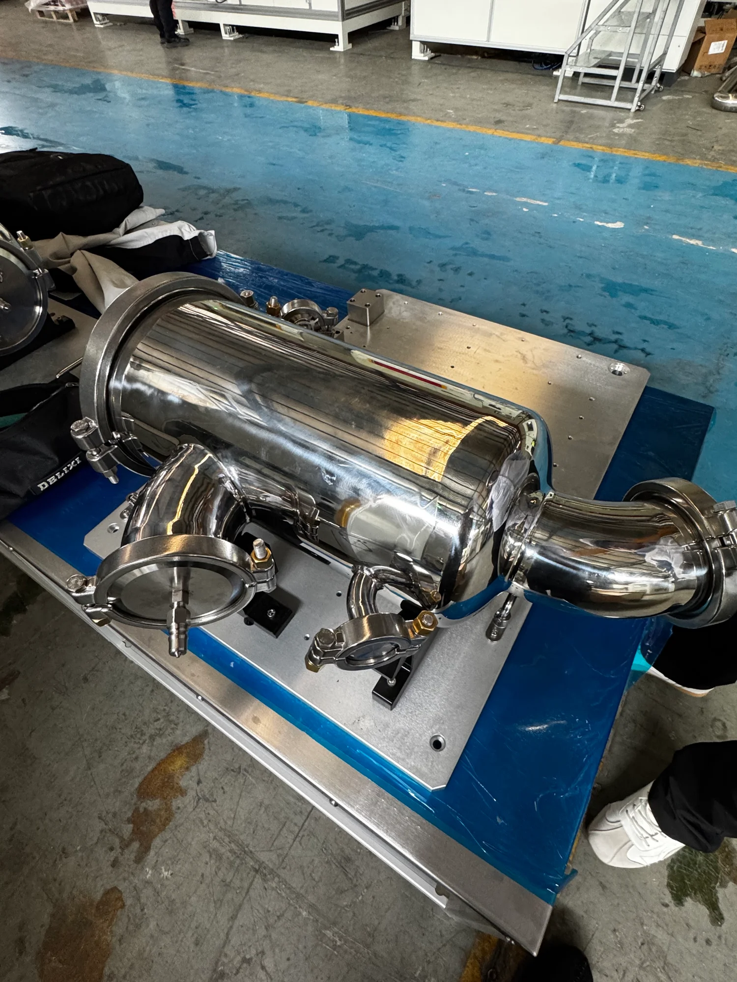 Stainless steel filter workpiece mounted on a sealing fixture in the workshop